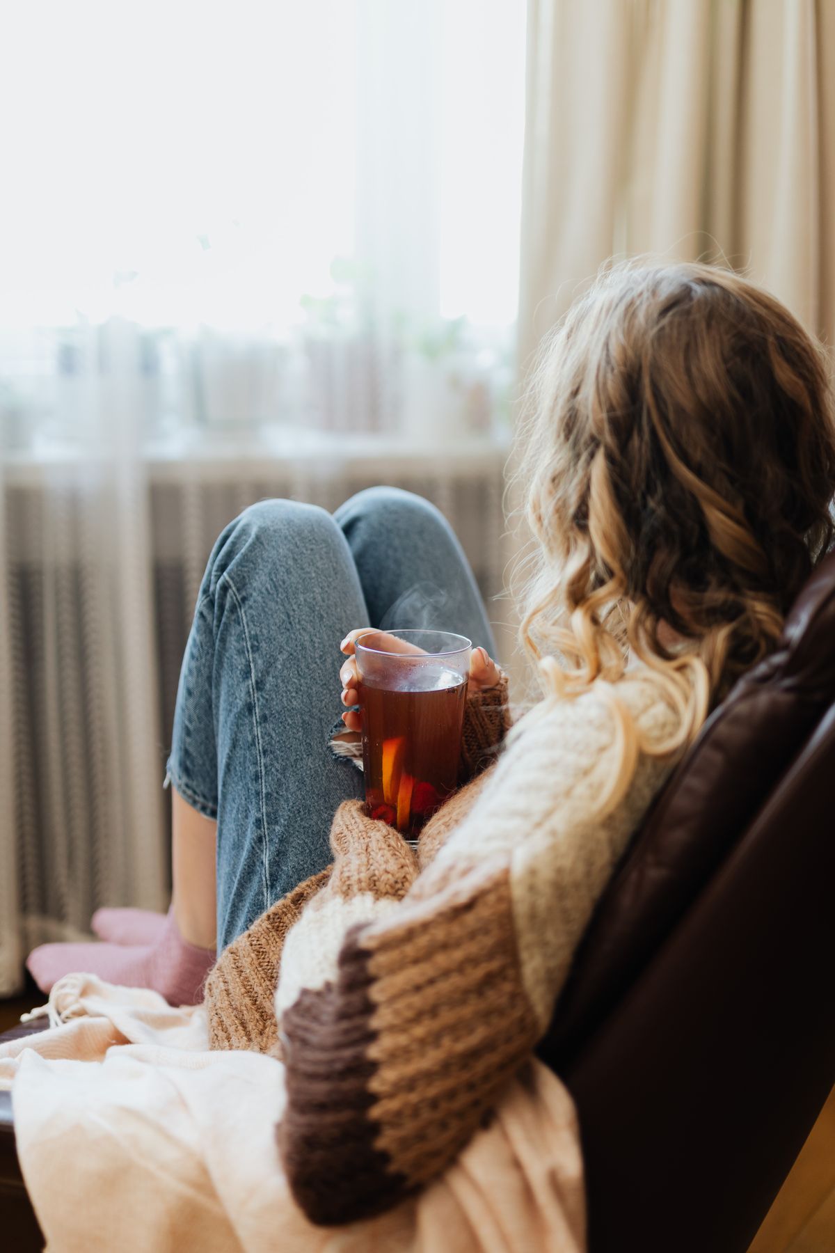 Woman enjoying a quiet moment with tea by the window