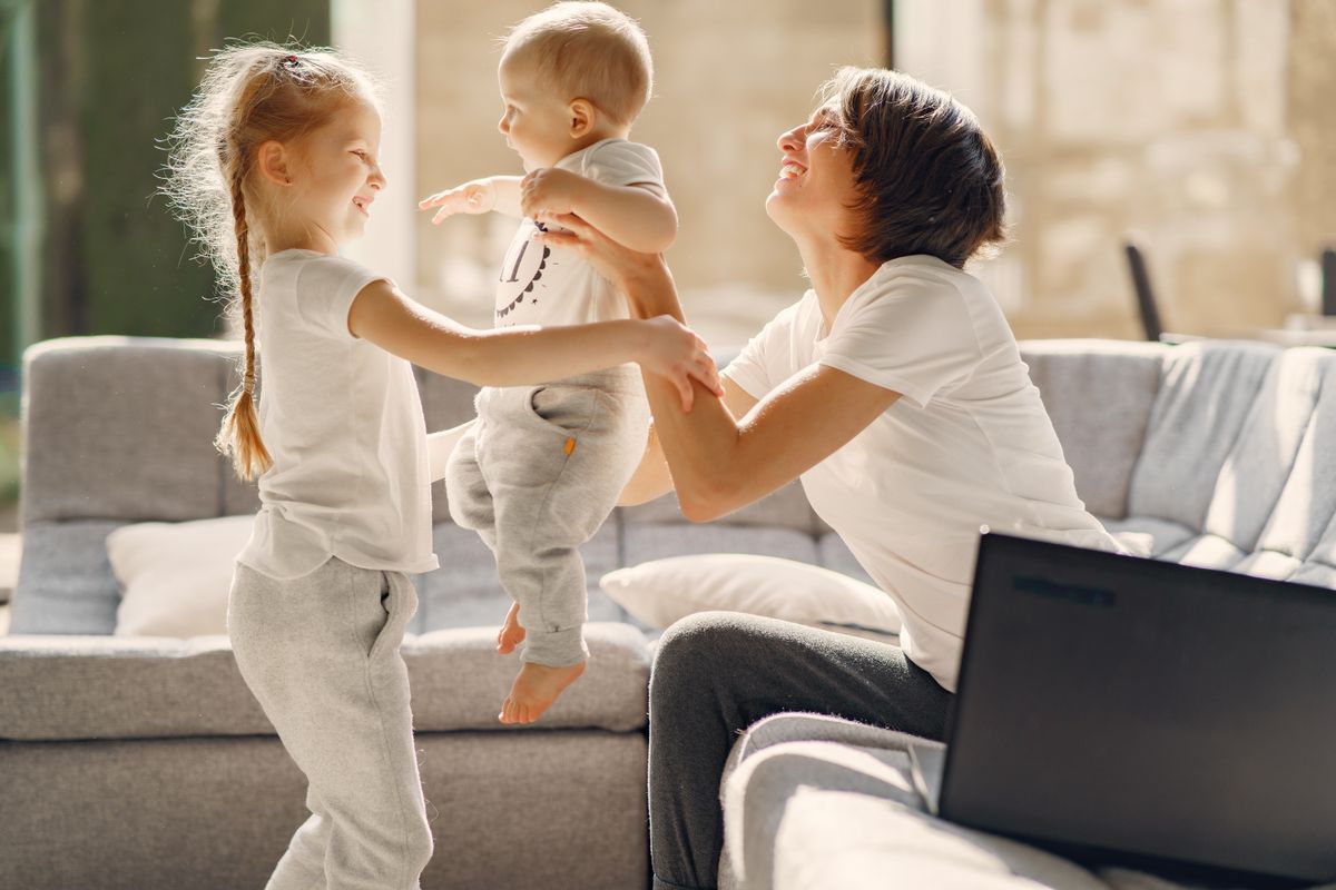 Mother laughing with her children at home